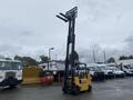 A 2010 Hyster S80XLBCS forklift with a tall forklift mast raised and a yellow body is positioned in the foreground
