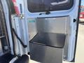 A metal storage compartment attached to the rear of a 2007 Chevrolet Express van