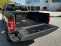 A 2022 RAM 3500 with a black bed liner visible in the truck bed and tailgate partially open showcasing the interior of the truck bed