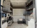 A 2016 Ford F-250 SD empty cargo space with metal shelves and storage compartments on the walls