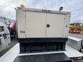 A 2005 Trailerman Generator Trailer with a beige enclosure displaying the label Katolight and a yellow beacon light on top