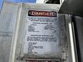 A danger notice on a 2011 Freightliner M2 106 detailing approved and unapproved materials for shredding with safety warnings
