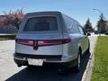 A silver 2013 Lincoln MKT hearse with a sloping rear and tinted windows parked on the side of the road