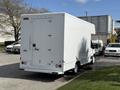 A white 2016 Ford Transit van with a boxy rear design and a single rear door parked in a lot