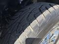 A close-up of a tire from a 2015 Ford F-150 showcasing the tread pattern and detailing of the rubber
