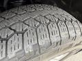 Close-up of a tire tread on a 2018 Chevrolet Silverado 1500 showcasing deep grooves and patterns designed for traction and grip on various terrains