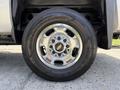 Close-up of a chrome wheel with the Chevrolet logo on a 2016 Chevrolet Silverado 2500HD mounted on a Goodyear Wrangler tire