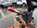 Close-up of the control panel and throttle lever of a 2012 Kubota F3680 with a gauge and various controls visible