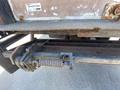 A close-up of the rear hitch of a 2014 International TerraStar showing rust and a coiled spring mechanism