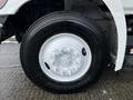 Close-up of a black tire mounted on a silver rim for a 2019 Hino 338 24 Foot Cube truck showing tread and bolt patterns