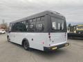 A 2017 Chevrolet Express bus with a white body and large windows displaying a sleek, modern design and rear lights