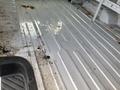 Interior of a 2008 Ford Econoline van showing a clean metal floor with some debris and stains
