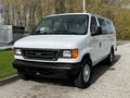 A white 2004 Ford Econoline van parked with its front facing the viewer showcasing its simple design and large windshield