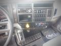 Dashboard of a 2021 Mack MD truck featuring controls a radio a gear shift and climate control knobs