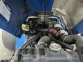 Close-up view of the engine compartment of a 2007 New Holland TN70A tractor showcasing various mechanical components and hoses