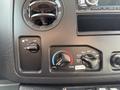 Control panel of a 2010 Ford Econoline featuring climate control knobs for fan speed temperature and air settings