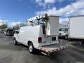 A white 2008 Ford Econoline van equipped with a utility bucket on top and a sturdy platform at the rear