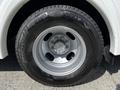 Close-up of a silver wheel and tire from a 2013 Chevrolet Express with visible tread and alloy rim
