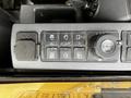 Control panel of a 2024 Caterpillar 306 featuring various switches and a dial for operating equipment