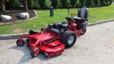 A red 2014 Ferris Mower ISX 800 with a sitting area and large mowing deck featuring multiple wheels for maneuverability