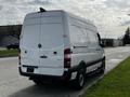 A 2017 Mercedes-Benz Sprinter van viewed from the rear with a white exterior and a sliding side door