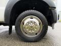 A close-up view of the wheel and tire of a 2011 Ford F-550 featuring a chrome wheel rim and a black tire with visible tread patterns