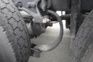 Close-up of the rear axle assembly including tires of a 2015 Kenworth T660 showing details of the suspension system and metal components
