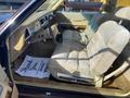 A 1982 Mercury Grand Marquis with tan interior featuring plush seats and a classic steering wheel is shown from the driver's side perspective