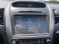 Dashboard display of a 2015 Kia Sorento featuring navigation options such as address and points of interest