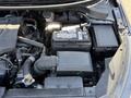 Close-up of the engine compartment of a 2018 Kia Rio5 showing the battery air filter and various engine components
