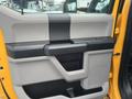 Interior door panel of a 2017 Ford F-250 SD featuring a gray and black design with a handle and storage compartment
