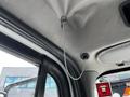 Interior view of the ceiling in a 2012 Freightliner M2 106 showing a metal cord attached to a hook