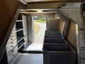Interior view of a 2009 Kenworth T270 with metal storage compartments and a large open space visible through the back door