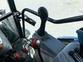 A close-up view of the control panel inside a 2018 New Holland Boomer 45 tractor featuring a gear shifter and various controls in the driver's area