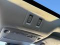 Interior overhead console of a 2021 Nissan Murano featuring buttons for the sunroof and interior lights