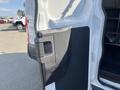 A close-up view of the rear door handle of a 2016 Ford Transit van with a black plastic cover and a metallic latch visible