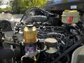 Close-up view of the engine bay of a 2021 Hino 338 showcasing various components including fuel filters hoses and fluid reservoirs