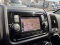 A close-up of the dashboard of a 2021 RAM Promaster featuring a touchscreen display with a navigation map and audio controls