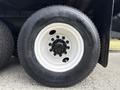 Close-up of a white six-bolt wheel with a black Michelin radial tire labeled XZAL 245 70R19 5
