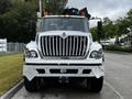A 2017 International WorkStar 7600 truck with a prominent front grille and large headlights featuring multiple orange roof lights and a sturdy front bumper