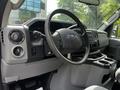 Interior of a 2018 Ford Econoline showing the steering wheel dashboard and control panel with various buttons and gauges