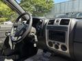 Interior view of a 2011 Chevrolet Colorado showing the steering wheel dashboard and audio controls