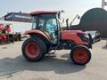 2014 Kubota tractor with an orange and black exterior large tires and a cabin with a windshield and protective frame
