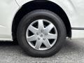A close-up of a silver alloy wheel on a 2009 Toyota Hiace featuring a Bridgestone tire with five spokes and visible bolts