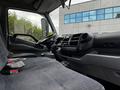 Interior of a 2014 Hino 195 featuring a driver's seat and dashboard with controls and displays
