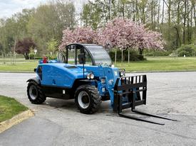 A blue 2020 Genie GTH-5519 telehandler with a front fork attachment and large tires