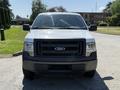 Front view of a 2014 Ford F-150 with a white exterior and black grille