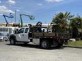 A 2012 Ford F-450 SD with a flatbed truck design featuring wooden planks and a crane mounted on the back