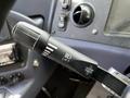 Close-up of a control lever for a 2022 Blue Bird BB Conventional bus with markings for lift and hazard cancel functions