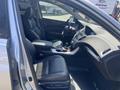 Interior of a 2017 Acura TLX showing leather seats a central console and dashboard with modern controls and features